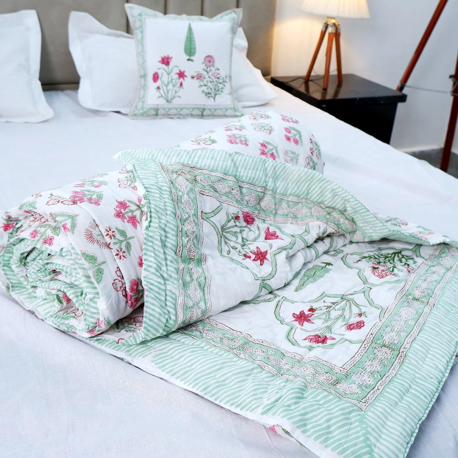 Jaipuri quilts double bed in floral design with green and white color scheme on a bed